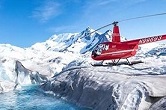 Helicopter flying over a glacier.